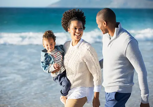Happy family having fun on beach 