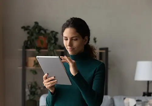 Latin woman browsing online on a tablet