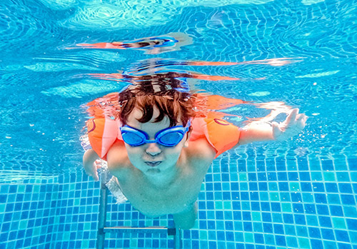 Child swimming under water.