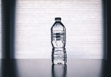 A bottled water is sitting on a table.