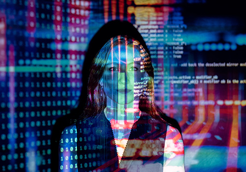 A woman is photographed with colorful computer code superimposed on her.