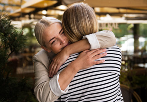 women hugging and trying forgiveness