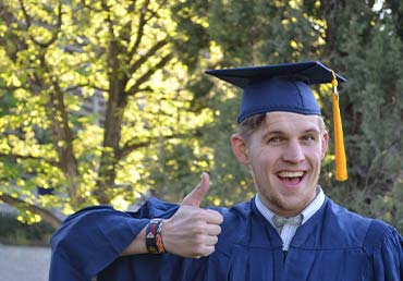 Young Man Thumbs Up College Graduate
