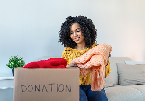 Woman donating clothes, embracing minimalism