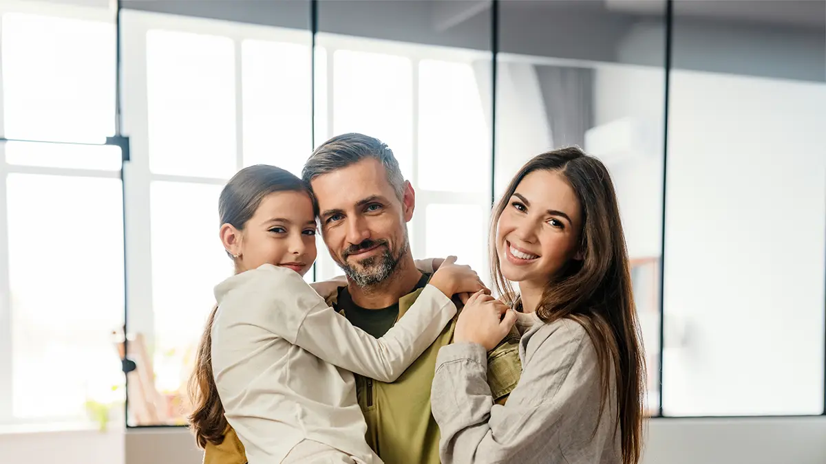 Happy family in their home, secured with life insurance