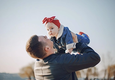 man holding child in the air