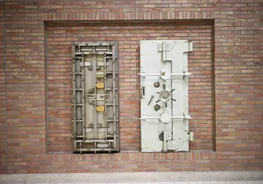 Square vault door on brick wall representing how an Irrevocable Life Insurance Trust (ILIT) protects life insurance policies from estate taxes.