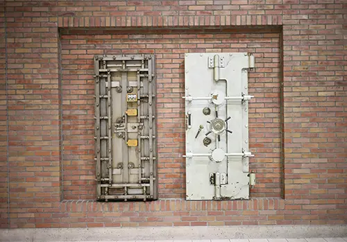 Square vault door on brick wall representing how an Irrevocable Life Insurance Trust (ILIT) protects life insurance policies from estate taxes.